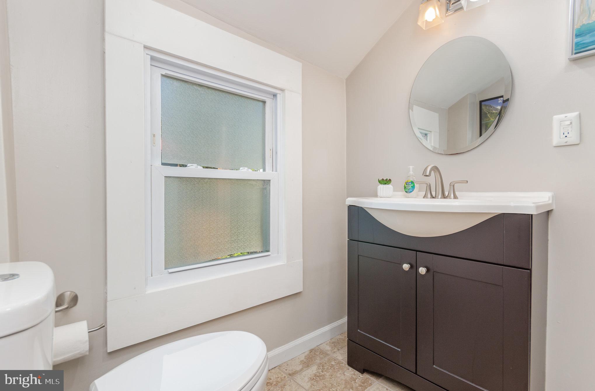 126 Prince George Street, Unit 4 Annapolis, MD 21401 - Photo 10 of 15 a bathroom with a sink vanity mirror and toilet