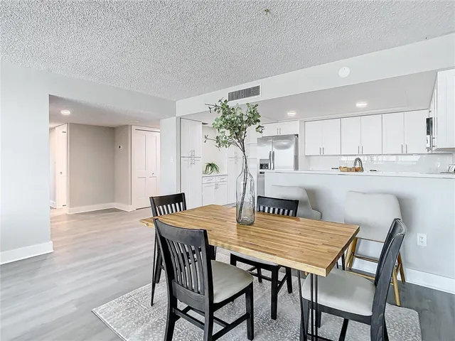 a dining room with furniture and wooden floor