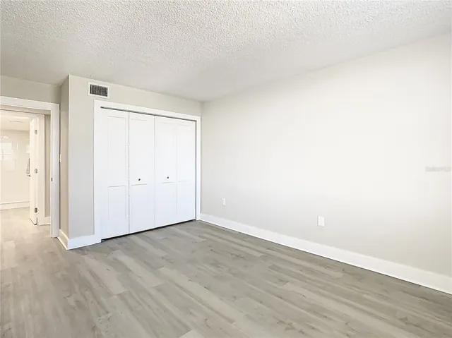 an empty room with wooden floor