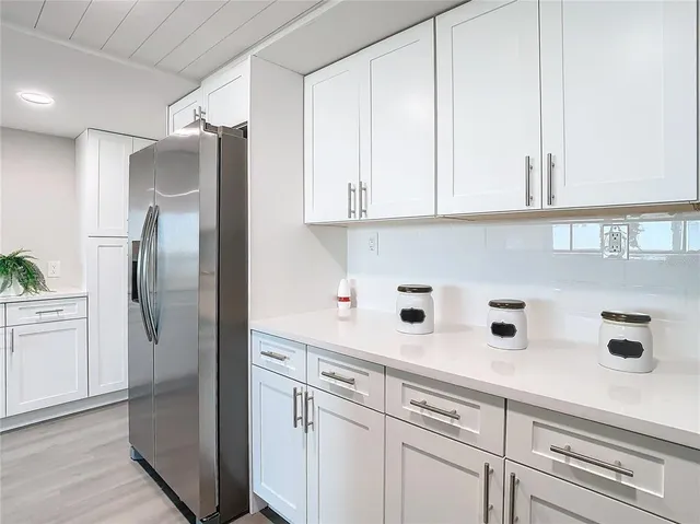 a kitchen with cabinets and stainless steel appliances