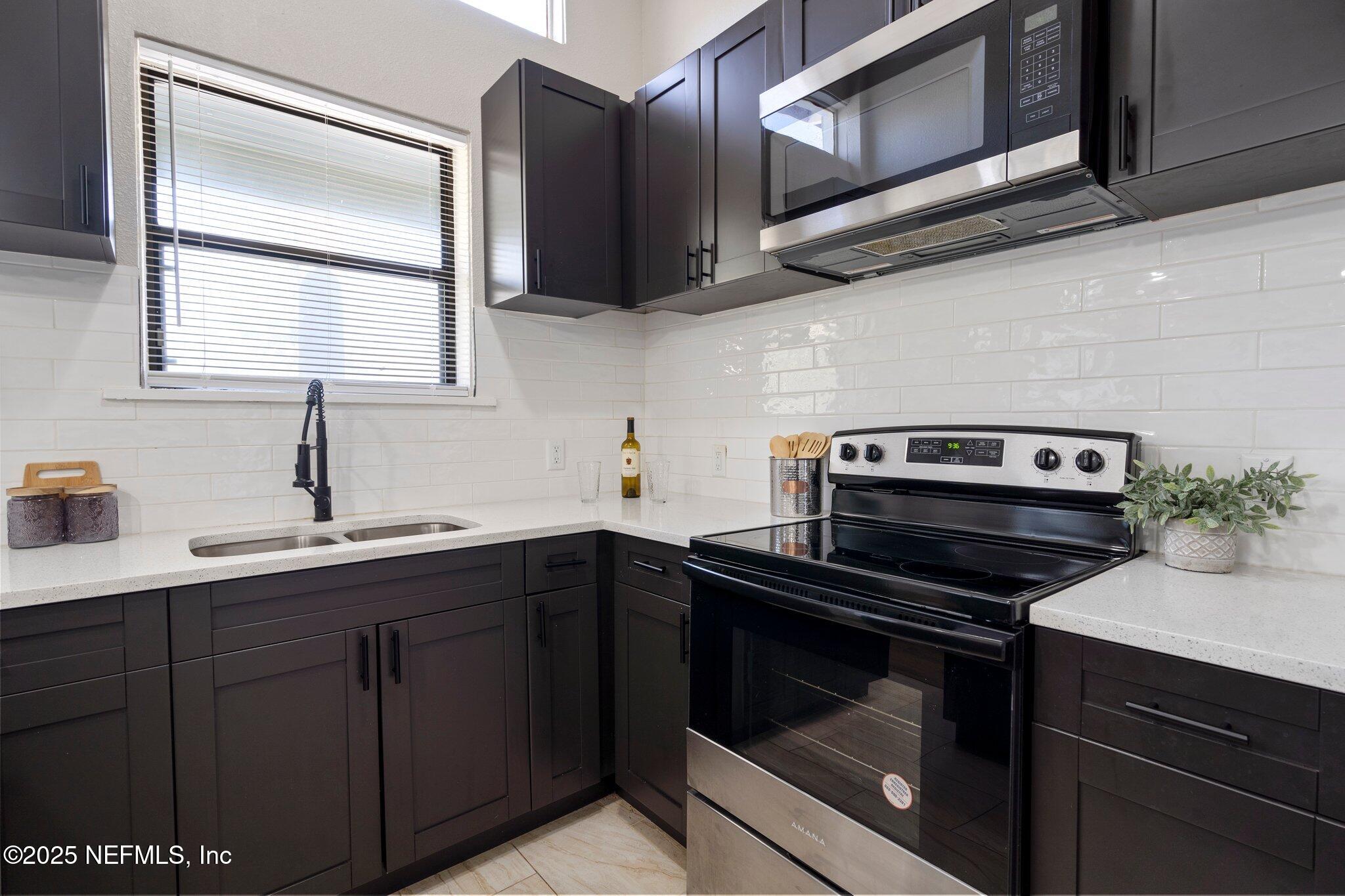 2838 Rainbow Road Jacksonville, FL 32217 - Photo 11 of 35 a kitchen with cabinets appliances and a sink