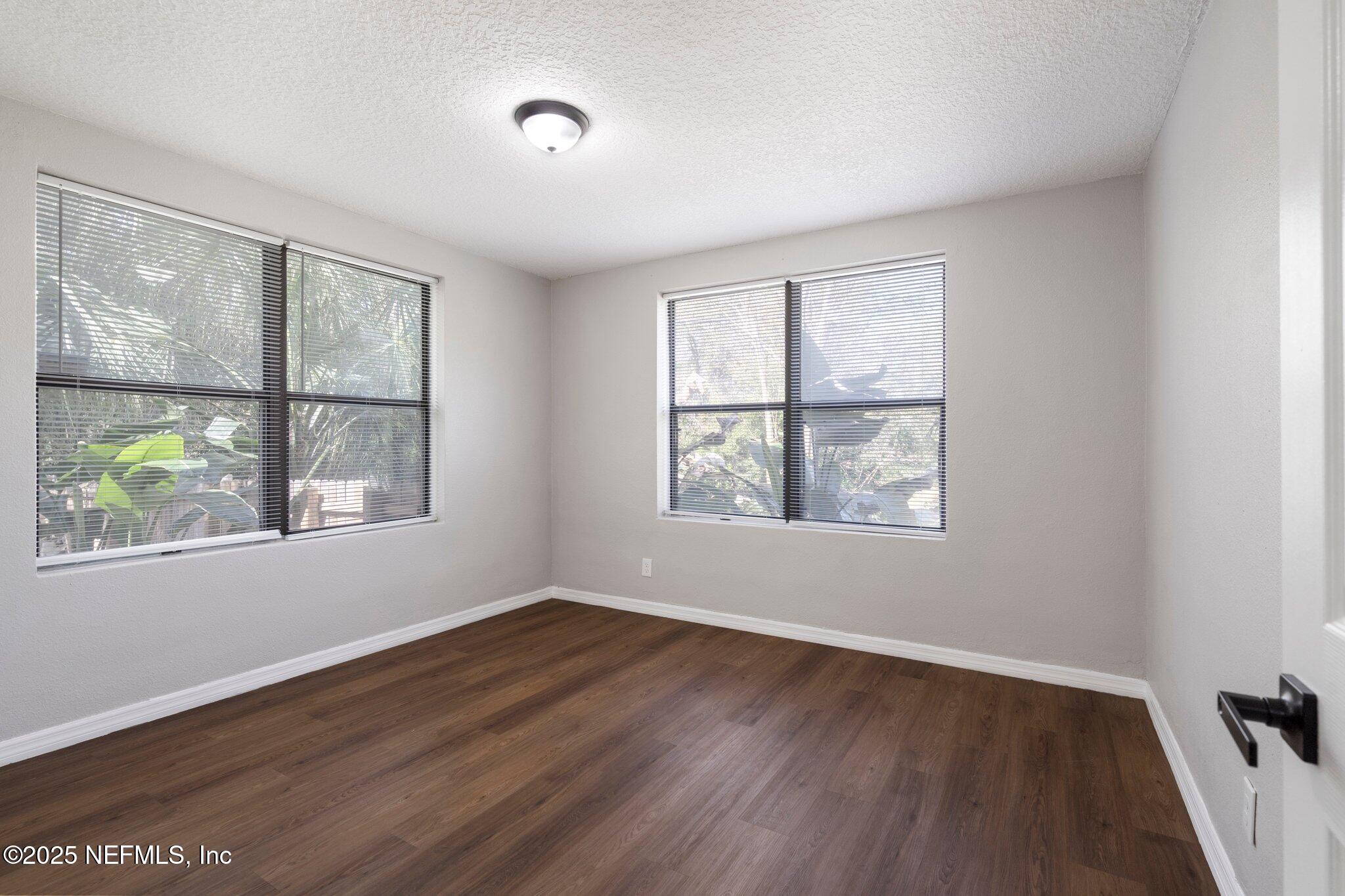2838 Rainbow Road Jacksonville, FL 32217 - Photo 23 of 35 an empty room with wooden floor and windows
