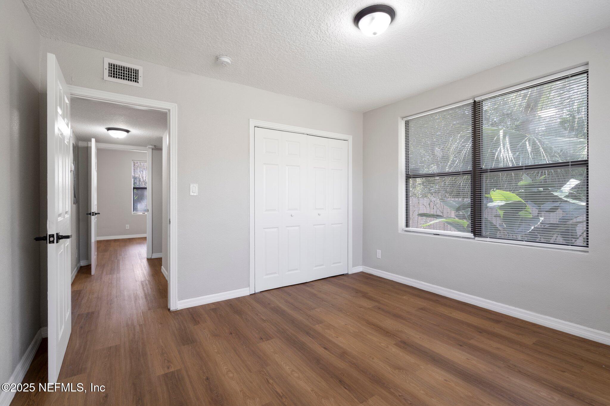 2838 Rainbow Road Jacksonville, FL 32217 - Photo 24 of 35 wooden floor in an empty room with a window