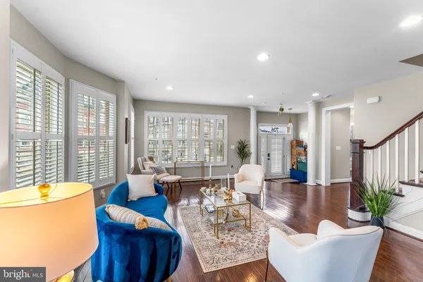 a living room with furniture and floor to ceiling windows