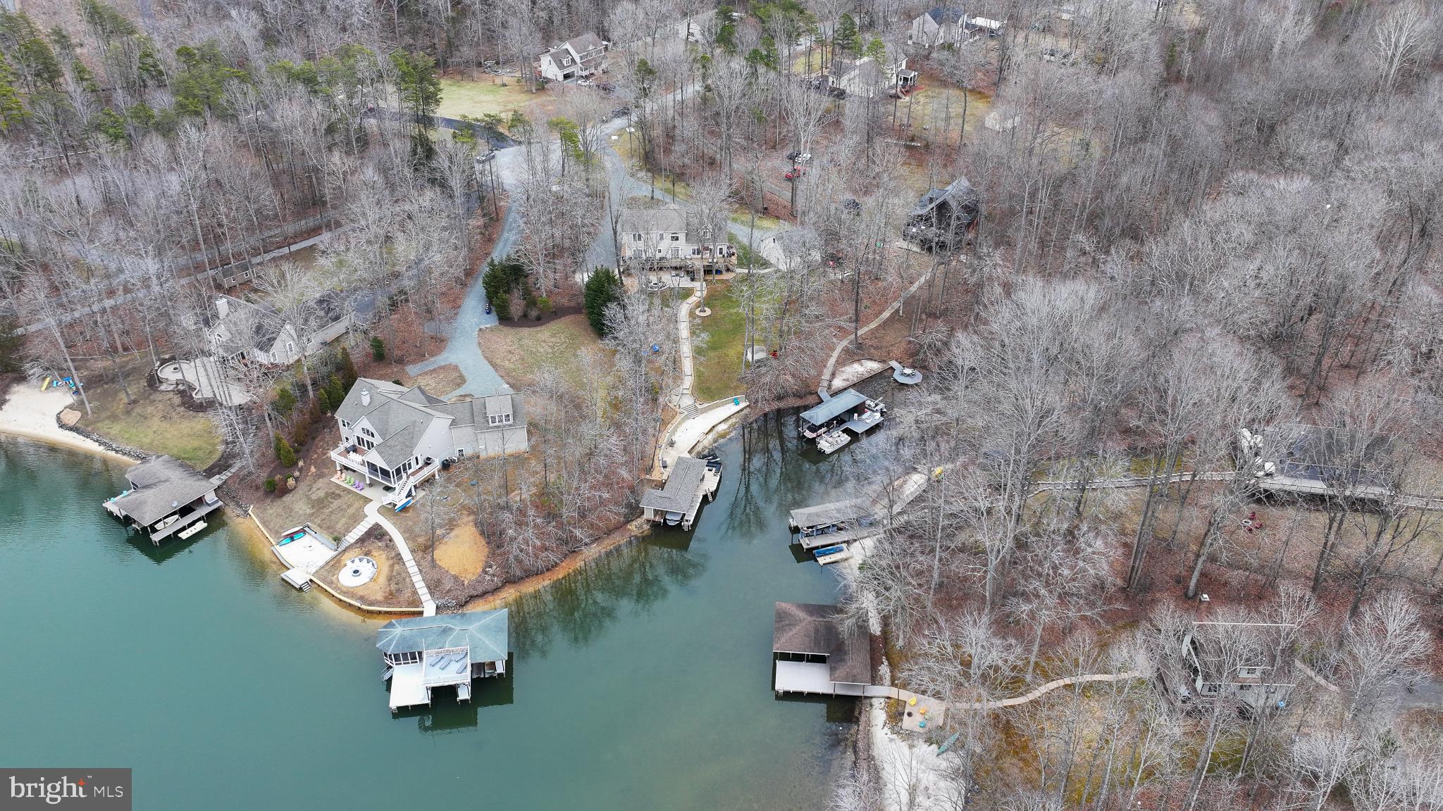 14 Elnor Road Bumpass, VA 23024 - Photo 62 of 69 Serene lakeside retreat in wooded landscape.