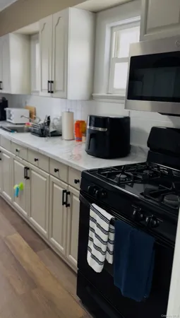 a kitchen with a stove and white cabinets