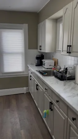 a kitchen with stainless steel appliances white cabinets and a sink