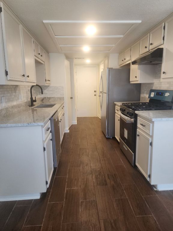 6905 Argonne Forest Cove, Unit B Austin, TX 78759 - Photo 1 of 18 a kitchen with stainless steel appliances granite countertop a sink stove and refrigerator