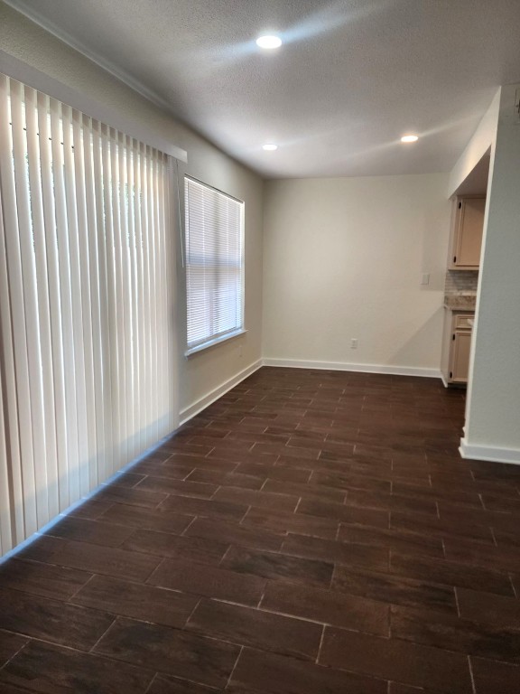 6905 Argonne Forest Cove, Unit B Austin, TX 78759 - Photo 4 of 18 an empty room with wooden floor and windows