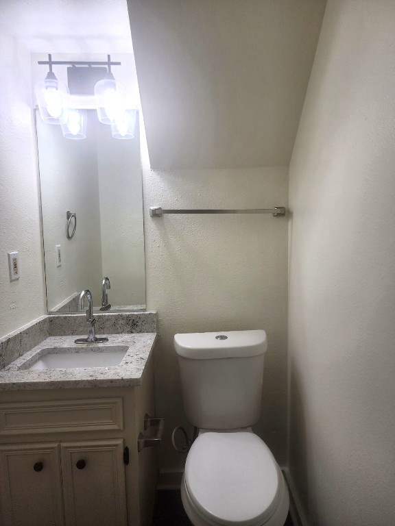 6905 Argonne Forest Cove, Unit B Austin, TX 78759 - Photo 6 of 18 a bathroom with a toilet a sink and mirror