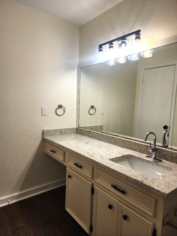 6905 Argonne Forest Cove, Unit B Austin, TX 78759 - Photo 9 of 18 a bathroom with a granite countertop sink a mirror and a