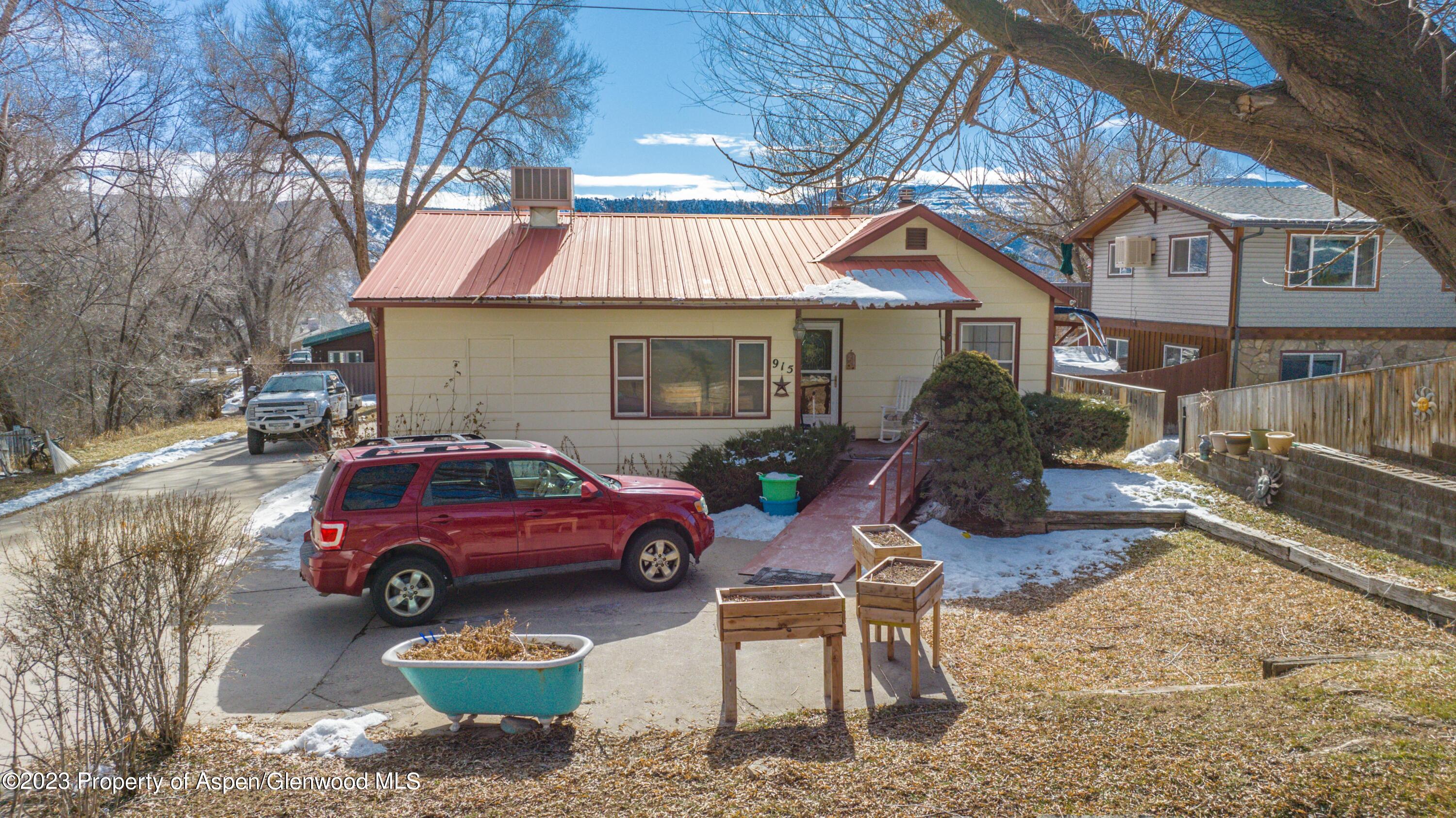915 East 7th Street Rifle, CO 81650 - Photo 3 of 22 a front view of a house with parking space