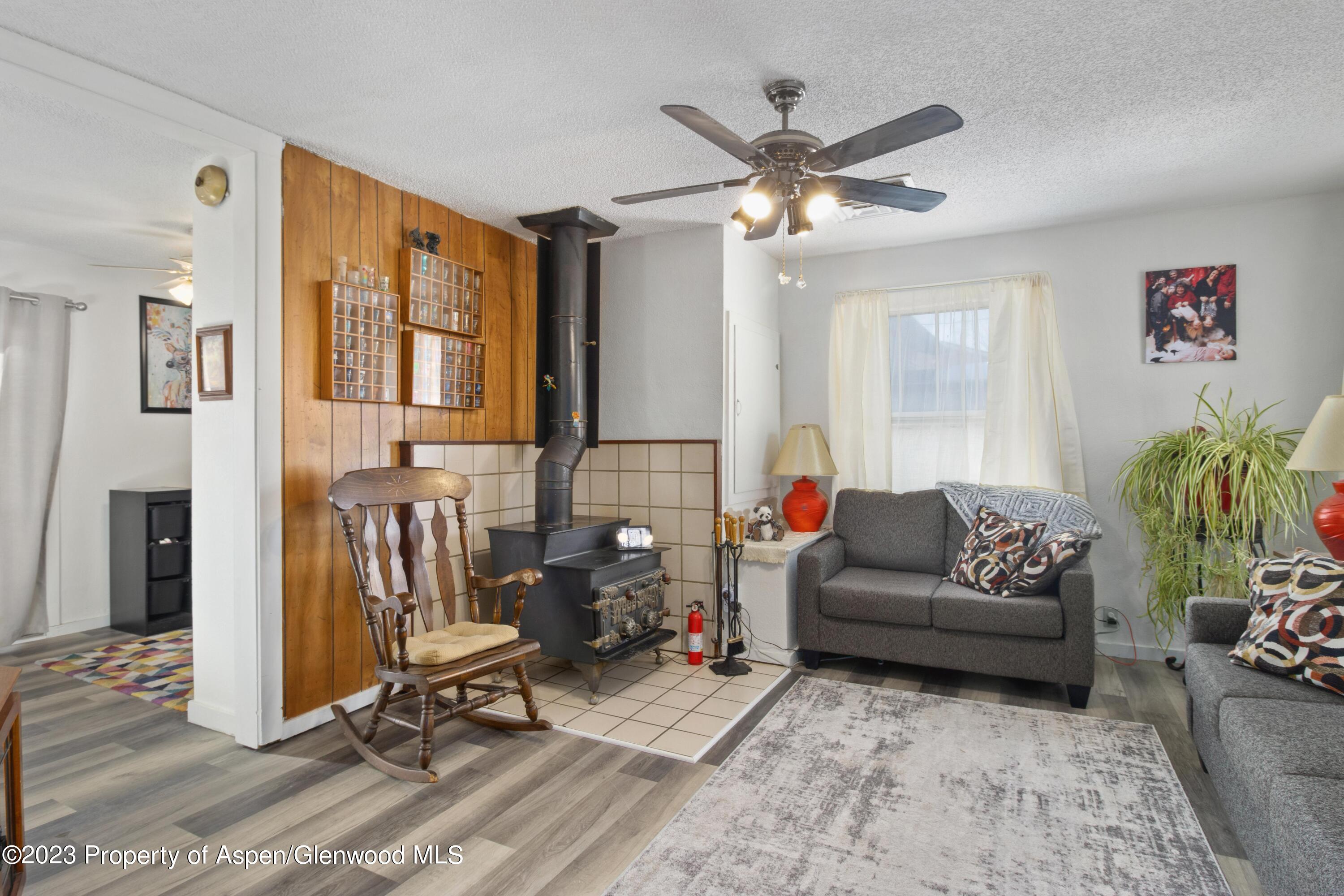 915 East 7th Street Rifle, CO 81650 - Photo 9 of 22 a living room with furniture and a chandelier