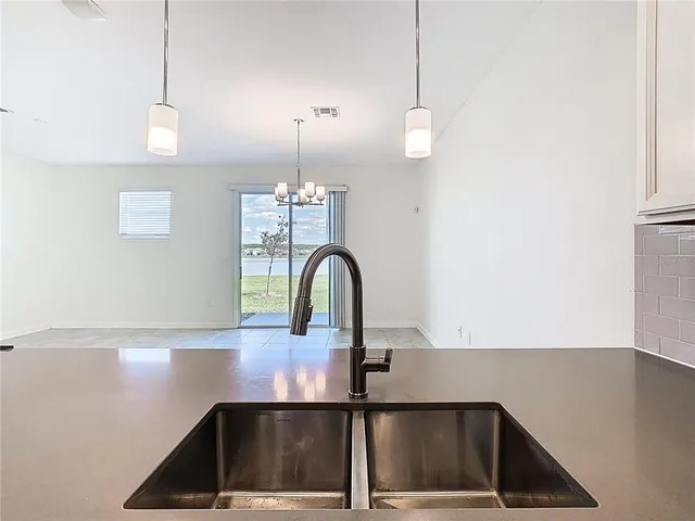 a kitchen with a sink a counter space and cabinets