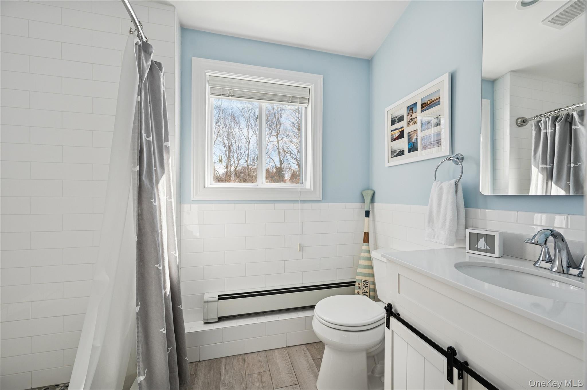 4 Stuart Court Hampton Bays, NY 11946 - Photo 12 of 20 a bathroom with a sink and a toilet
