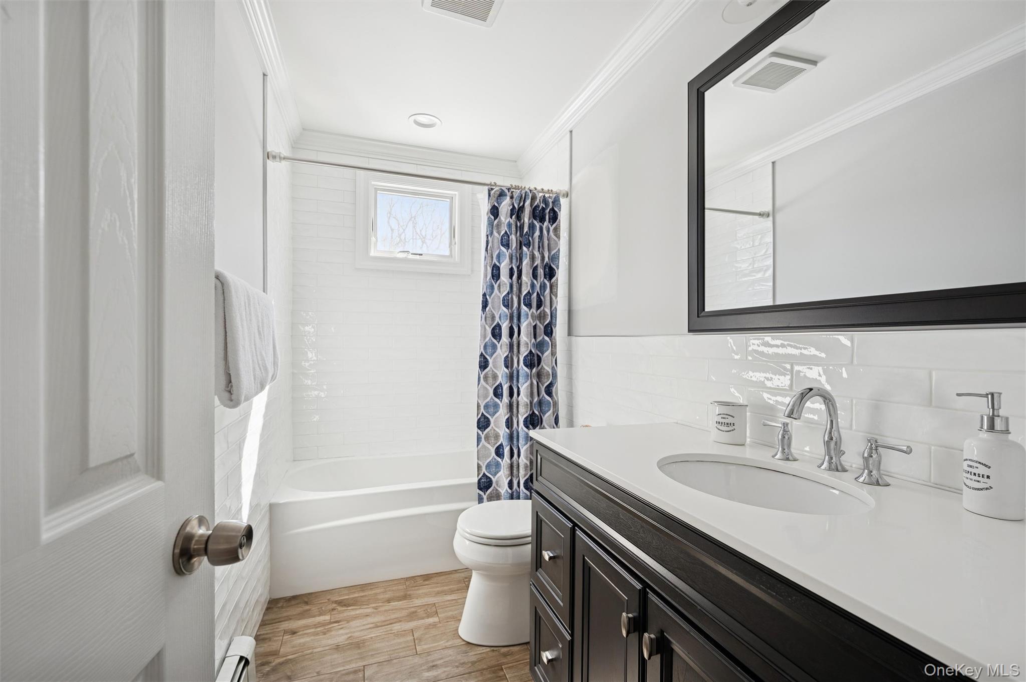 4 Stuart Court Hampton Bays, NY 11946 - Photo 14 of 20 a bathroom with a sink a toilet and shower