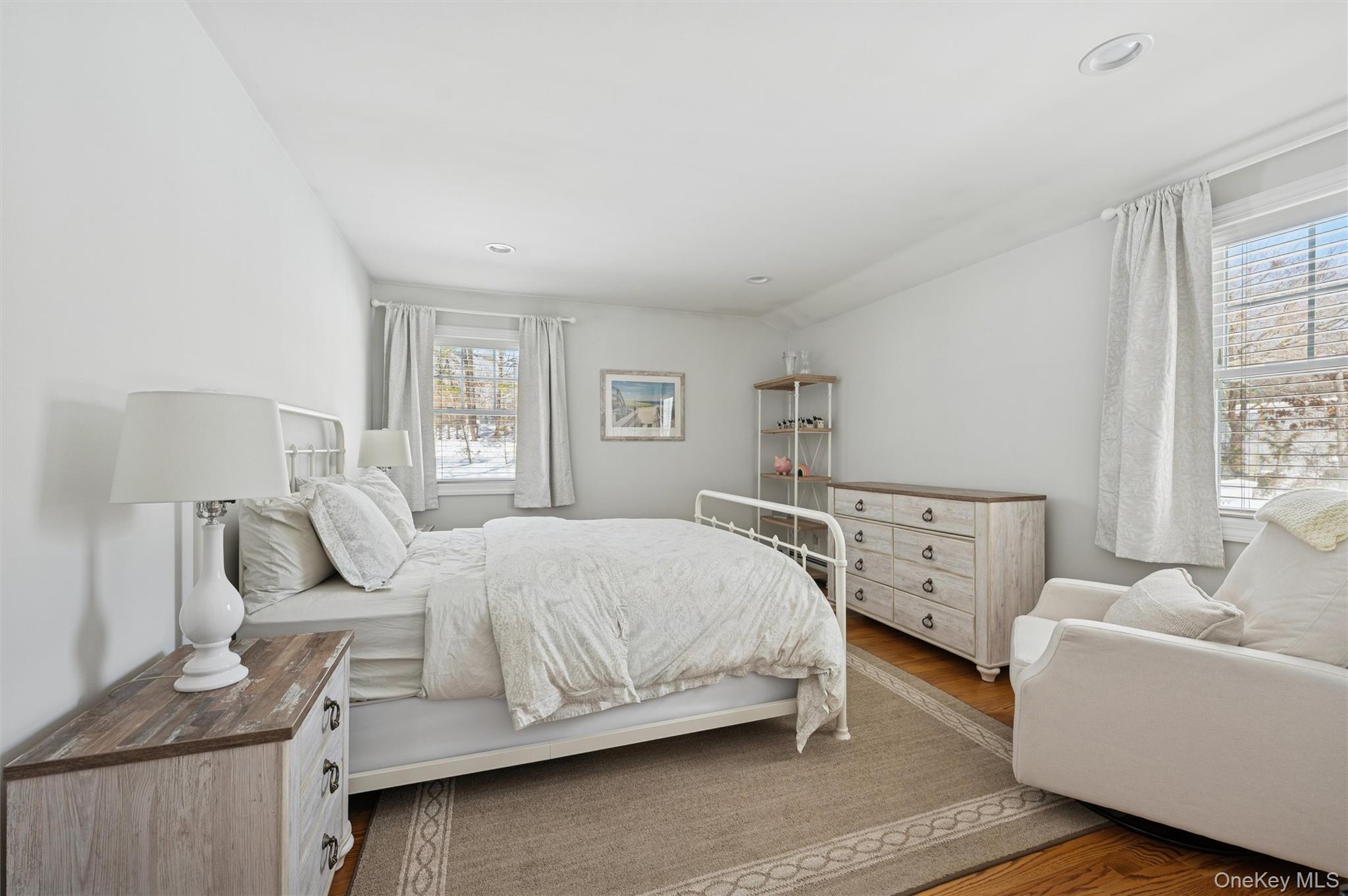 4 Stuart Court Hampton Bays, NY 11946 - Photo 15 of 20 a bedroom with a bed and wooden floor