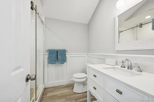 a bathroom with a sink toilet and shower