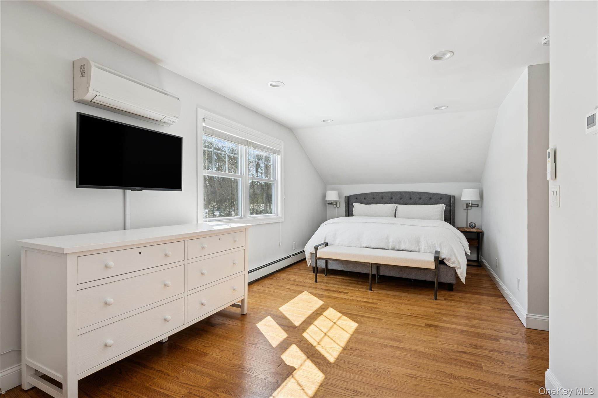 4 Stuart Court Hampton Bays, NY 11946 - Photo 17 of 20 a bedroom with a bed and a flat screen tv