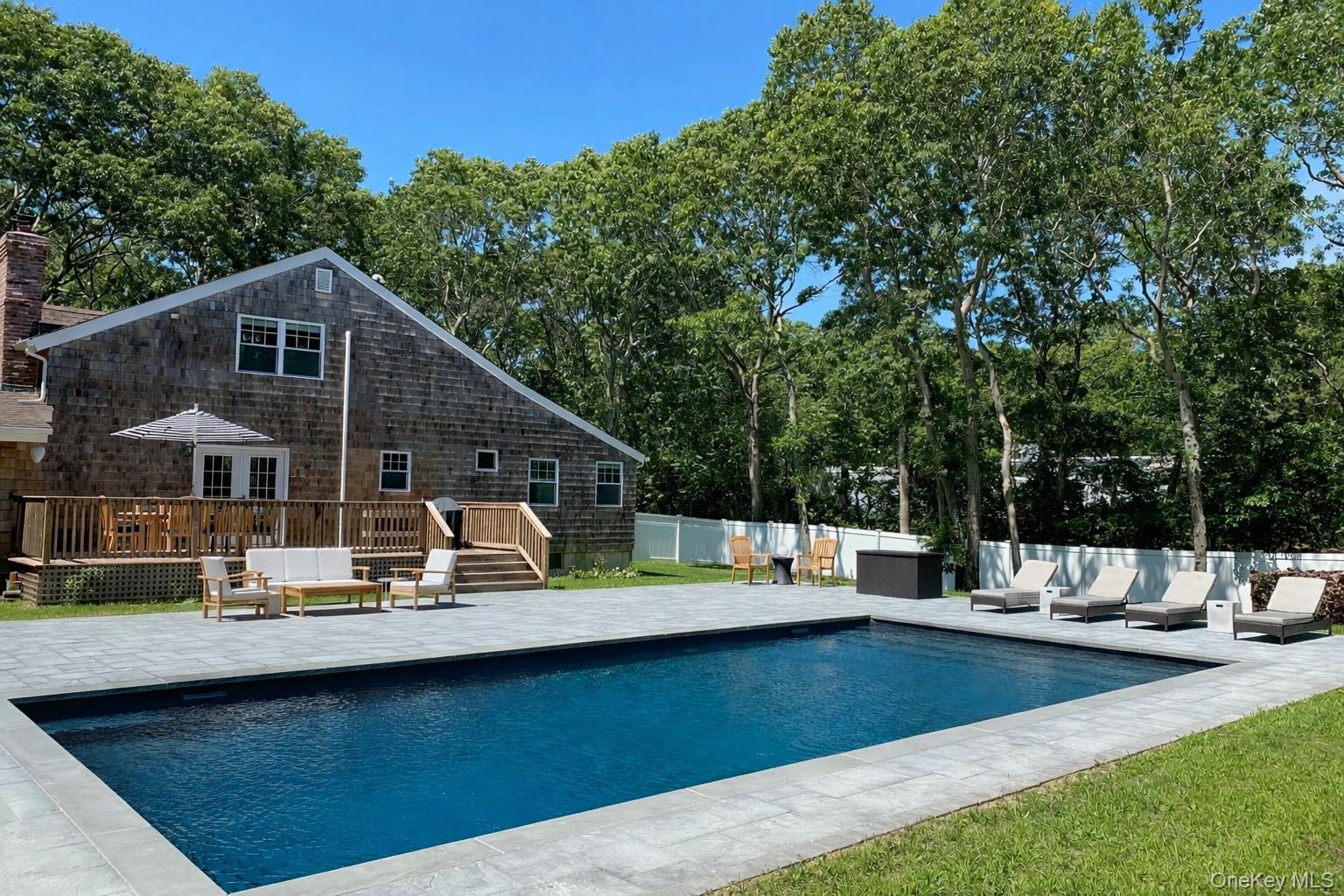 4 Stuart Court Hampton Bays, NY 11946 - Photo 19 of 20 a view of a house with backyard and sitting area