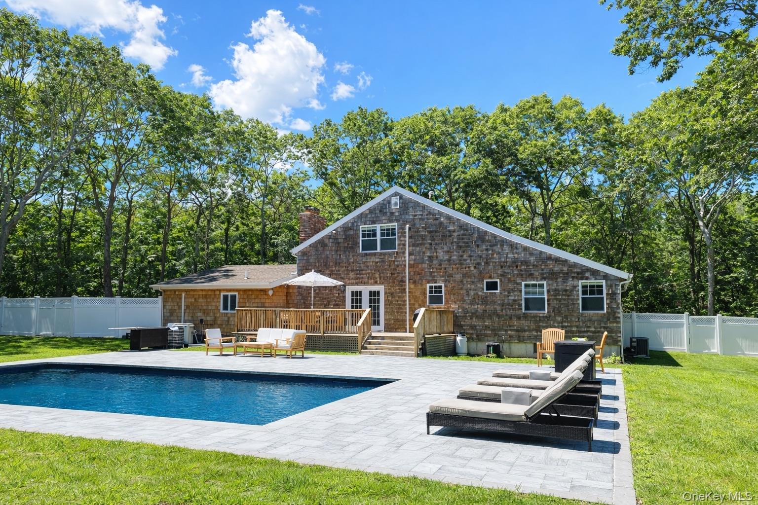 4 Stuart Court Hampton Bays, NY 11946 - Photo 20 of 20 a front view of a house with swimming pool having outdoor seating