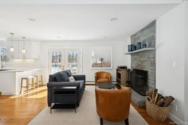 a living room with furniture a fireplace and a flat screen tv