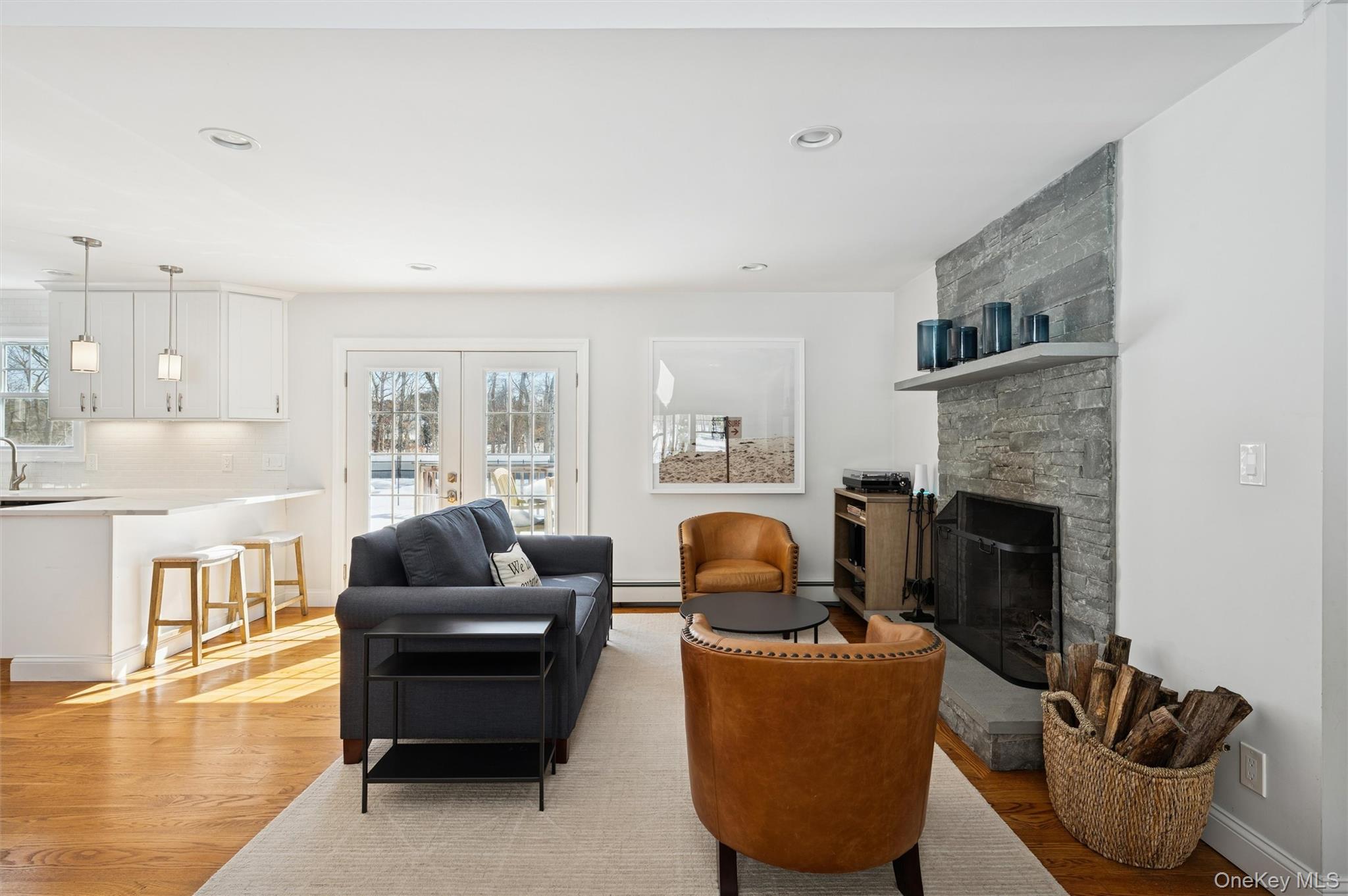 4 Stuart Court Hampton Bays, NY 11946 - Photo 4 of 20 a living room with furniture a fireplace and a flat screen tv