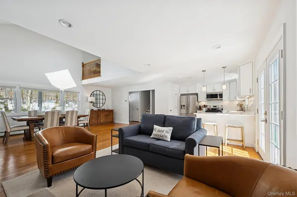 a living room with furniture and a view of kitchen