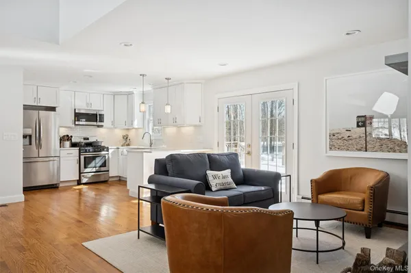 a living room with furniture and kitchen view