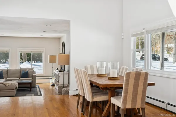 a dining room with furniture and wooden floor
