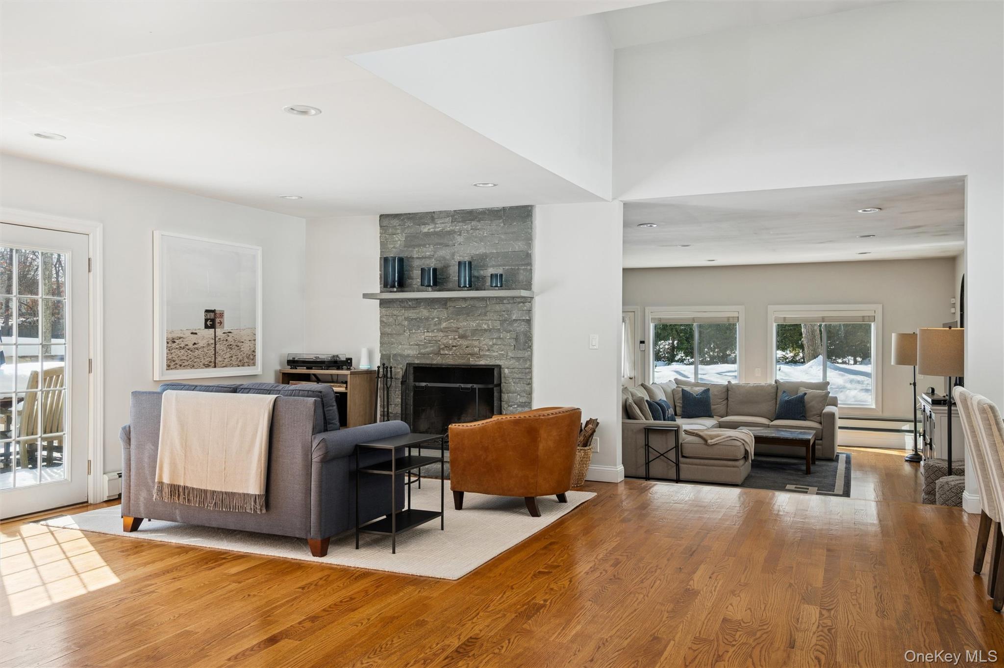 4 Stuart Court Hampton Bays, NY 11946 - Photo 8 of 20 a living room with furniture and a fireplace