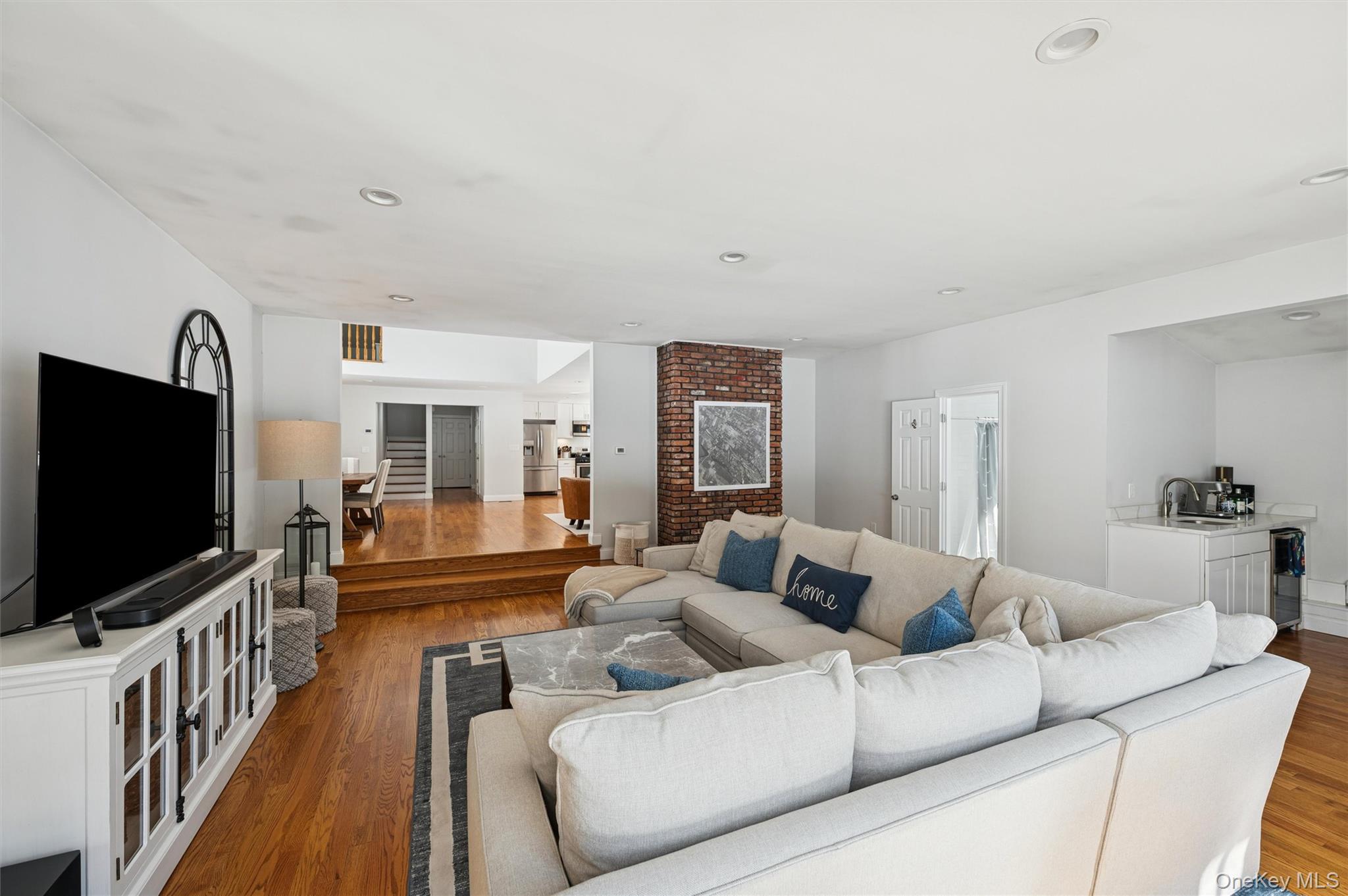 4 Stuart Court Hampton Bays, NY 11946 - Photo 10 of 20 a living room with furniture and a flat screen tv