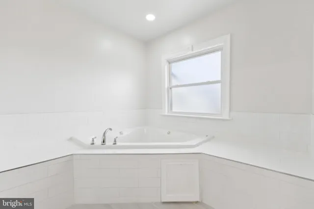 a bathroom with a bathtub and a sink