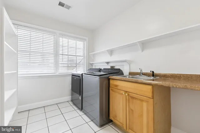 a utility room with cabinets washer and dryer