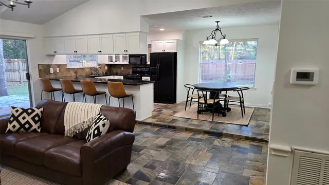 a living room with couches and chandelier