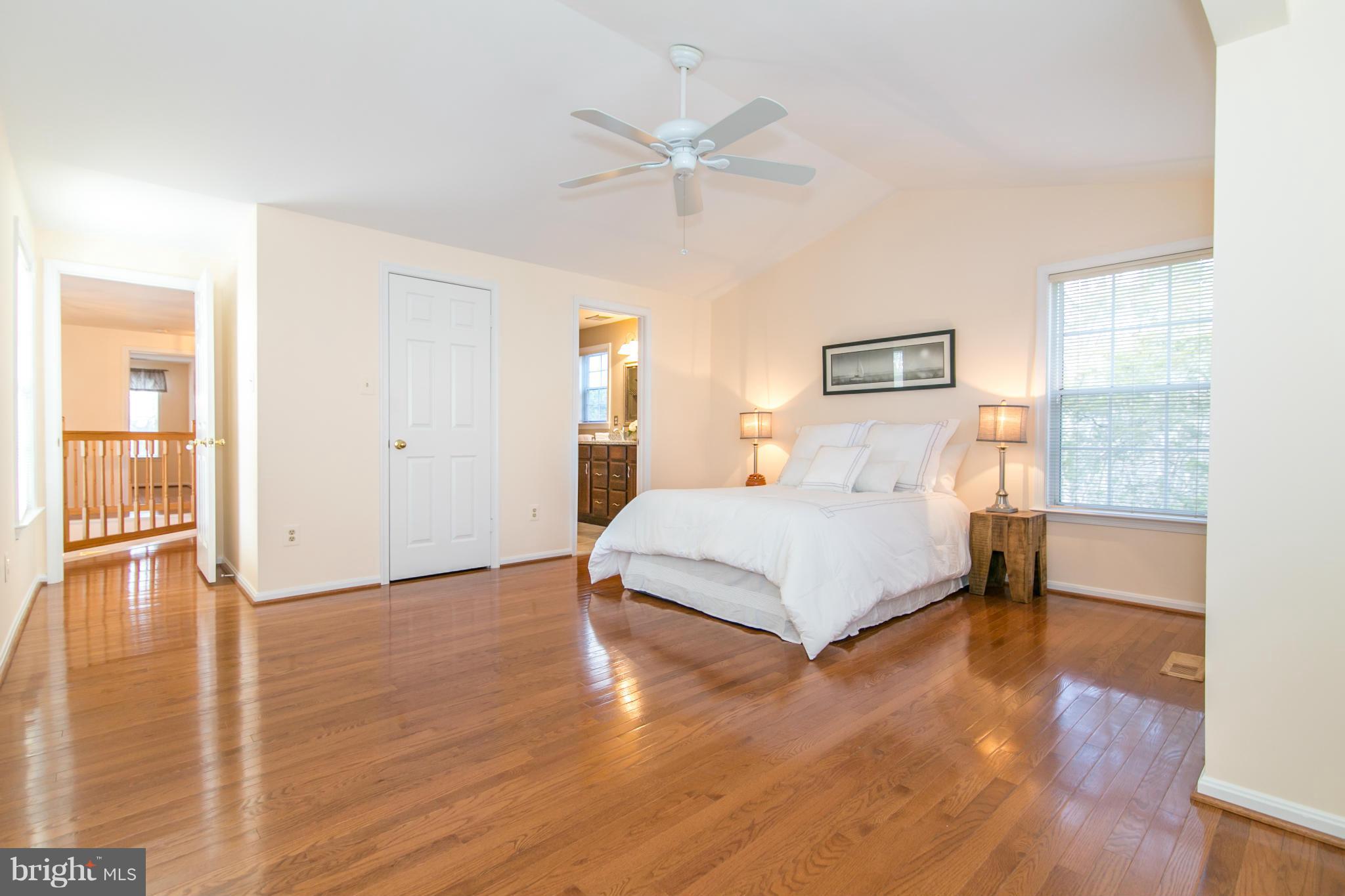 1510 Deer Point Way Reston, VA 20194 - Photo 13 of 30 a bedroom with a large bed and a ceiling fan