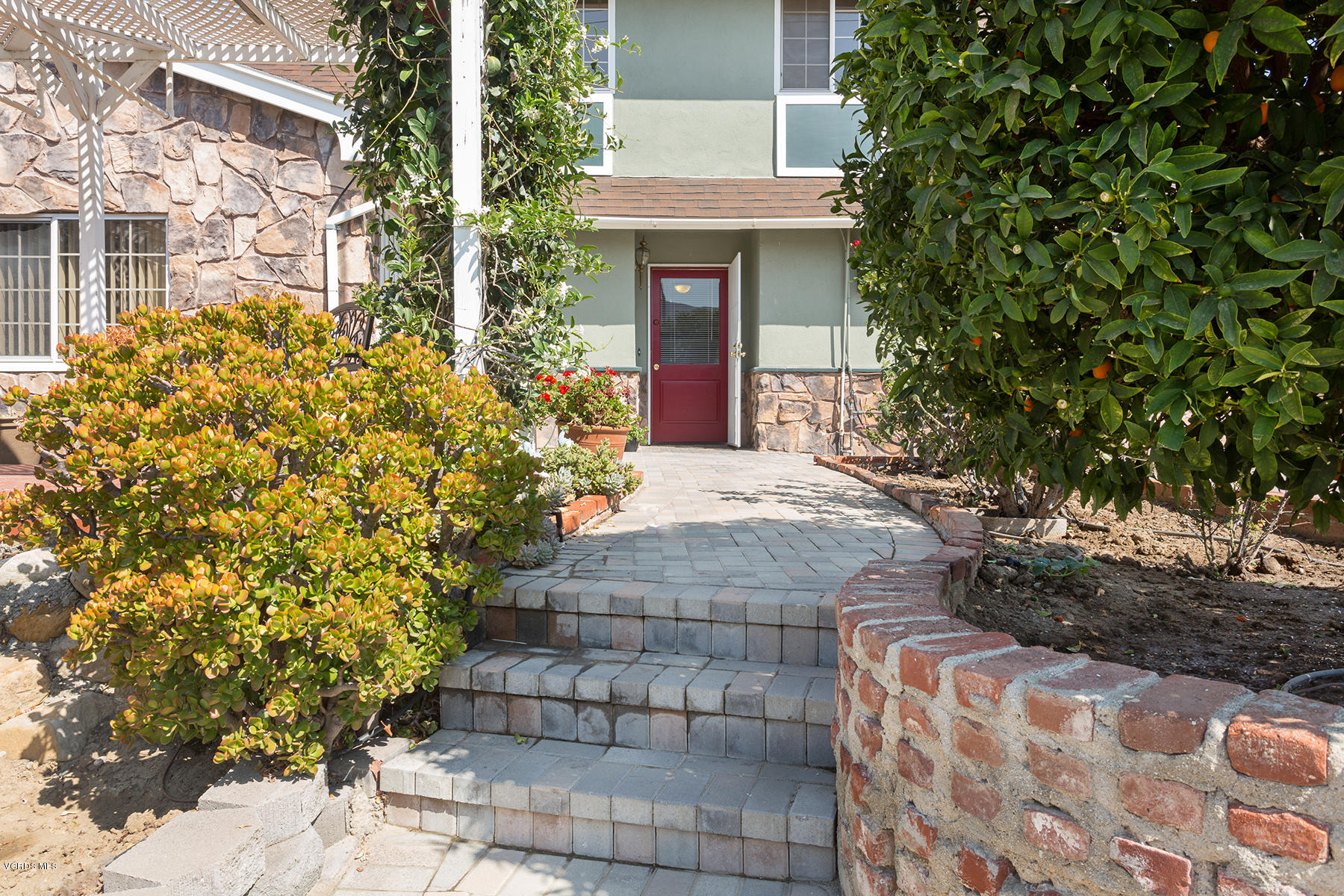 2459 Fitzgerald Road Simi Valley, CA 93065 - Photo 3 of 28 a front view of a house with a garden