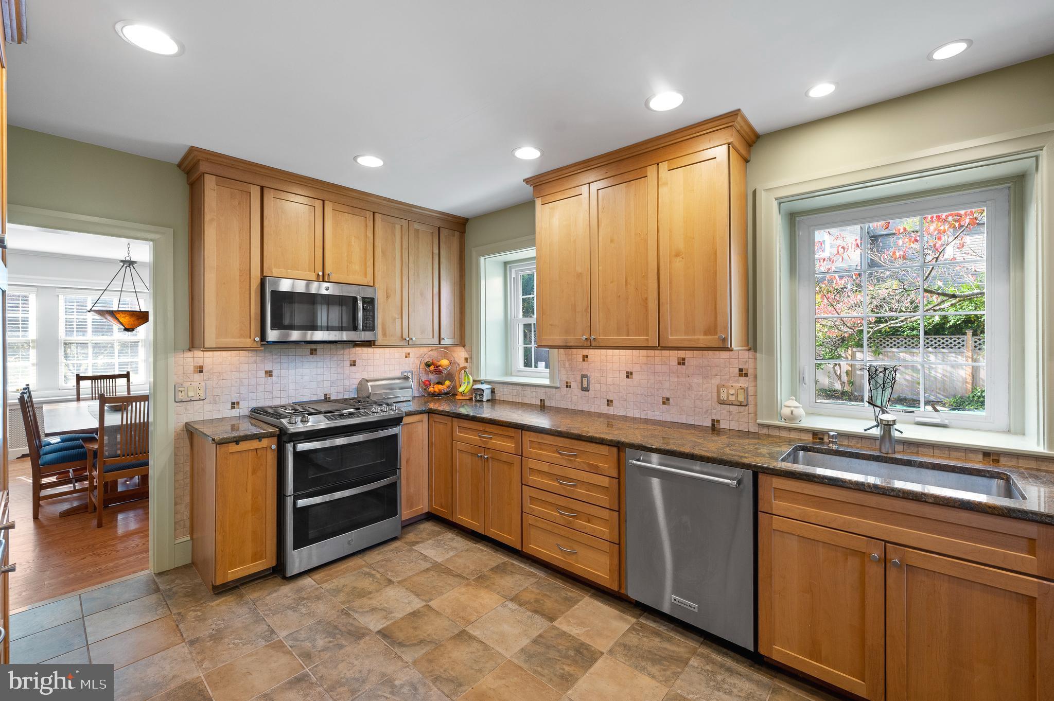 7 West Amherst Road Bala Cynwyd, PA 19004 - Photo 12 of 40 a kitchen with stainless steel appliances granite countertop wooden cabinets a sink dishwasher a stove and a refrigerator