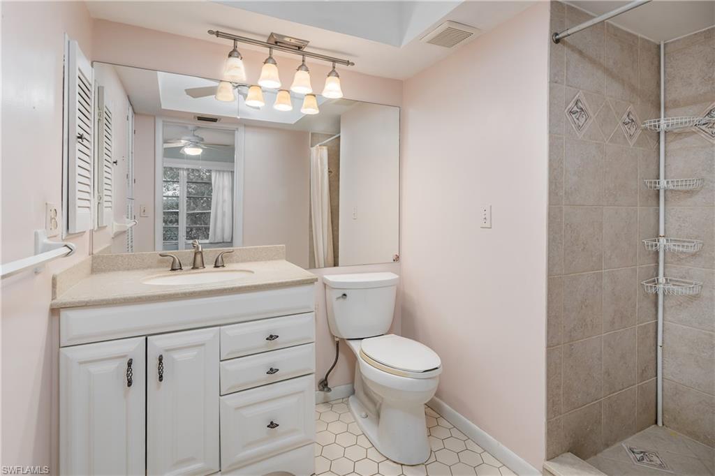 28 Watercolor Way, Unit 28 Naples, FL 34113 - Photo 11 of 29 a spacious bathroom with a granite countertop sink a toilet and a mirror
