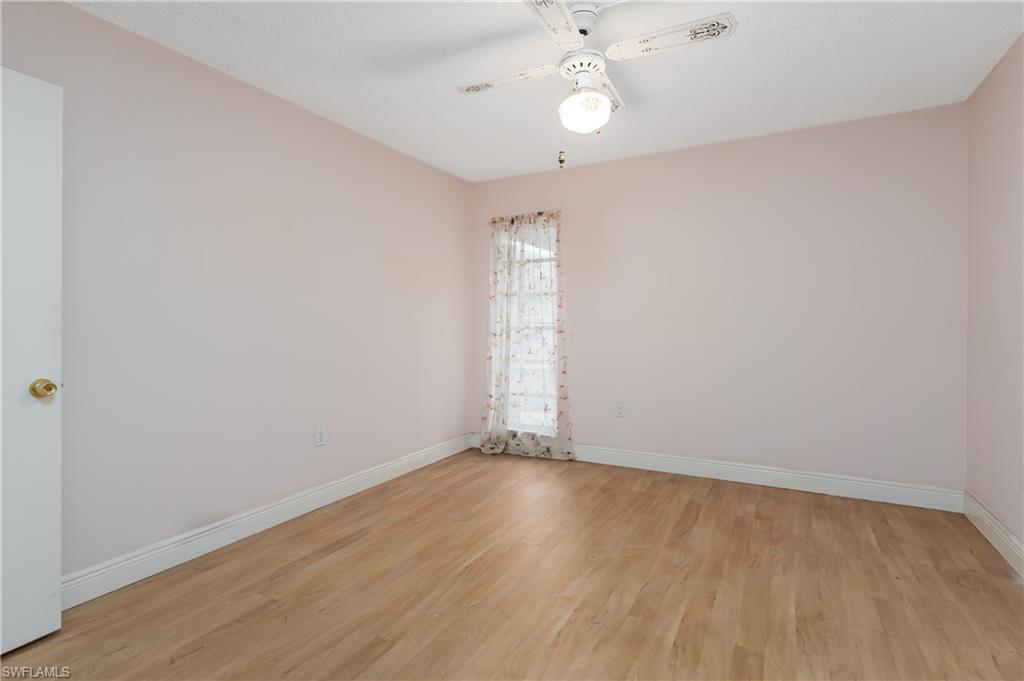 28 Watercolor Way, Unit 28 Naples, FL 34113 - Photo 15 of 29 an empty room with wooden floor and windows
