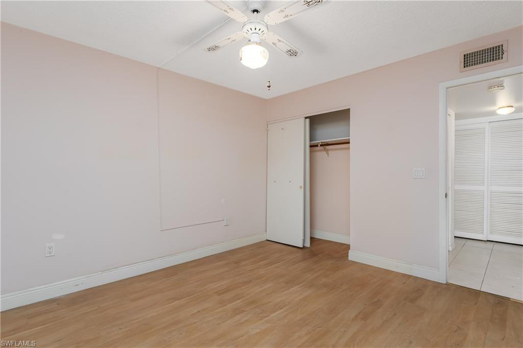28 Watercolor Way, Unit 28 Naples, FL 34113 - Photo 16 of 29 wooden floor in an empty room