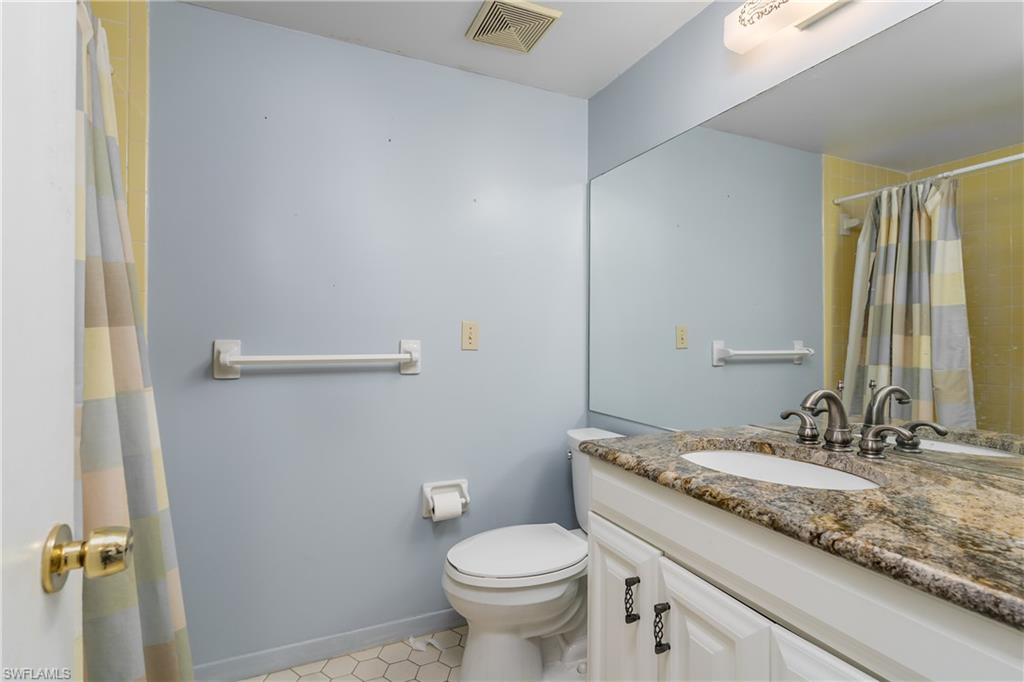 28 Watercolor Way, Unit 28 Naples, FL 34113 - Photo 18 of 29 a bathroom with a granite countertop sink toilet and a mirror