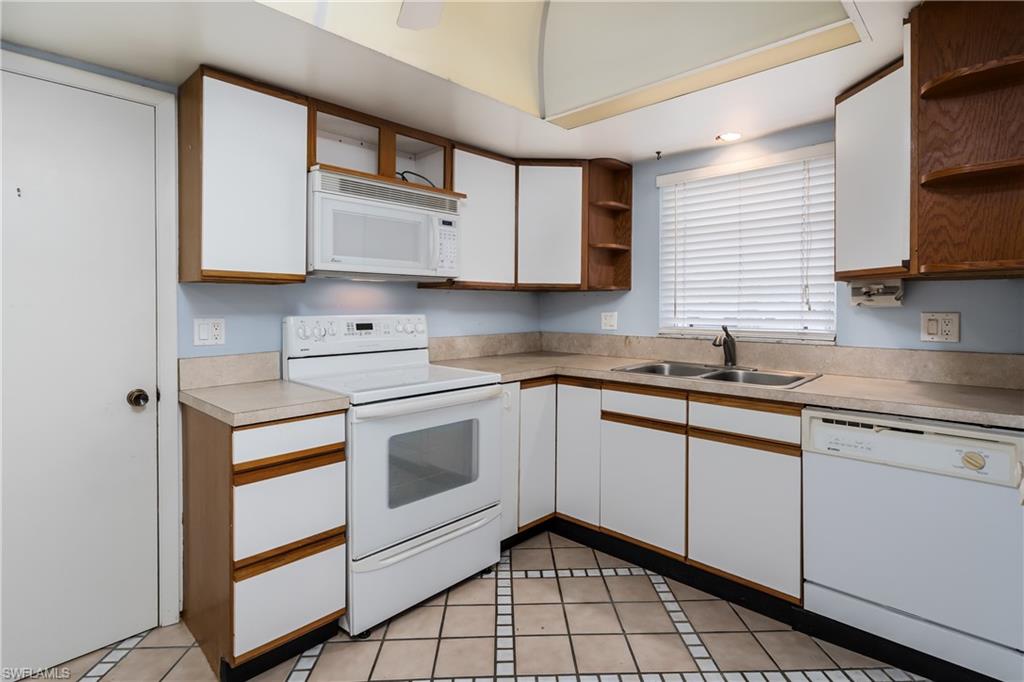 28 Watercolor Way, Unit 28 Naples, FL 34113 - Photo 20 of 29 a kitchen with stainless steel appliances granite countertop a sink a stove and cabinets