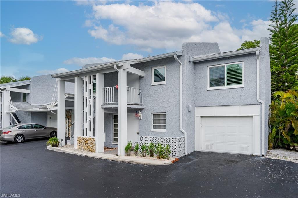 28 Watercolor Way, Unit 28 Naples, FL 34113 - Photo 2 of 29 a couple of cars parked in front of a house