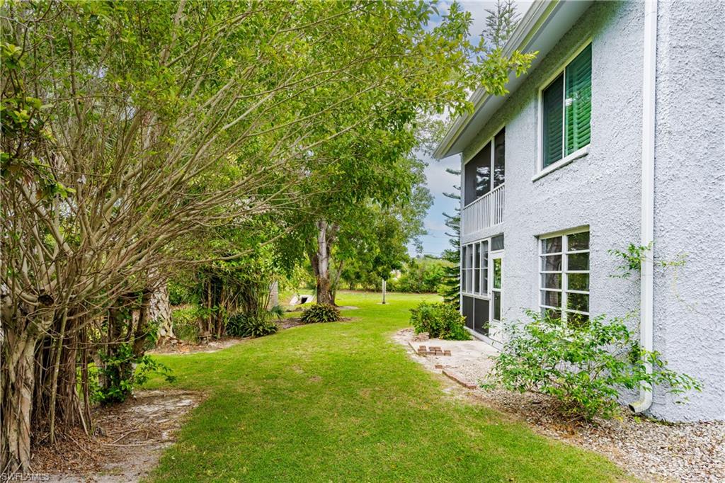 28 Watercolor Way, Unit 28 Naples, FL 34113 - Photo 23 of 29 a view of a yard in front of a house