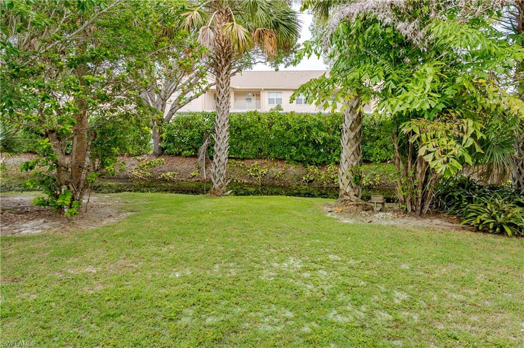 28 Watercolor Way, Unit 28 Naples, FL 34113 - Photo 24 of 29 a view of a backyard with a garden