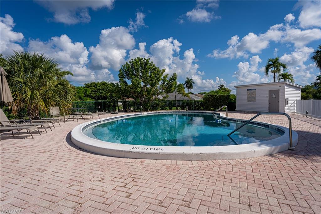 28 Watercolor Way, Unit 28 Naples, FL 34113 - Photo 25 of 29 a view of a swimming pool with a yard