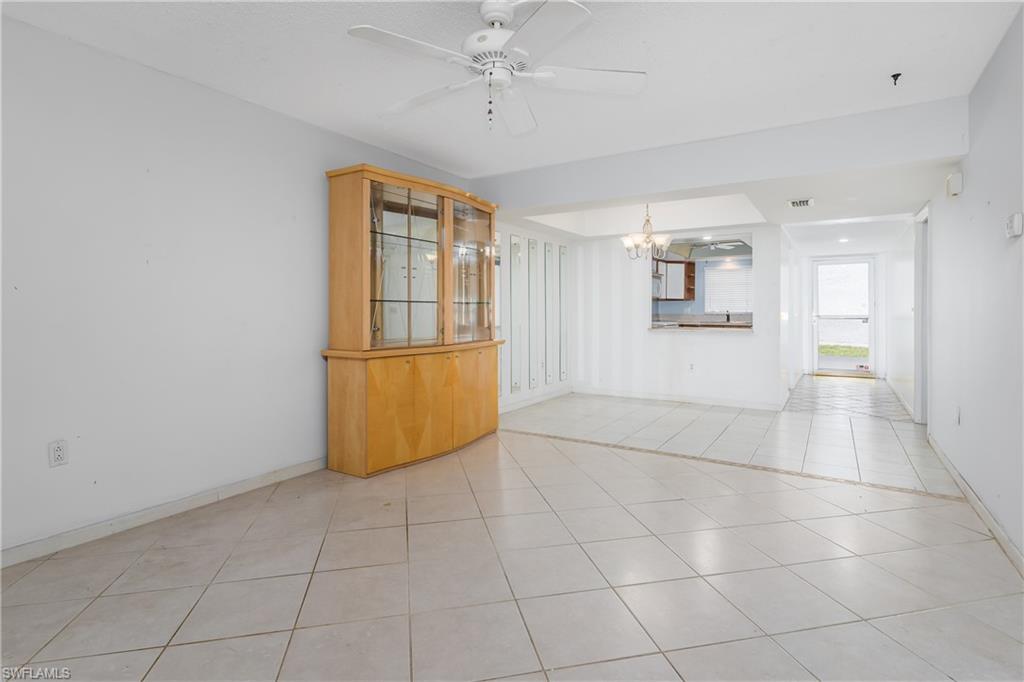 28 Watercolor Way, Unit 28 Naples, FL 34113 - Photo 6 of 29 a view of a livingroom with wooden floor a ceiling fan and windows