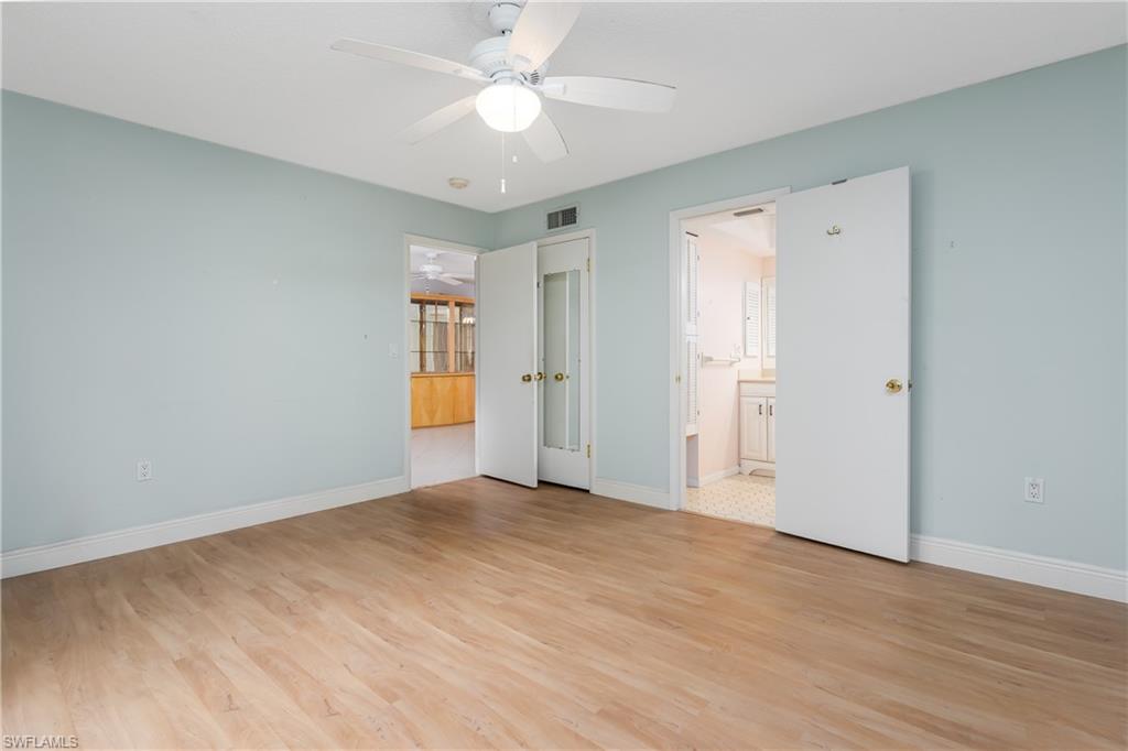 28 Watercolor Way, Unit 28 Naples, FL 34113 - Photo 9 of 29 wooden floor in an empty room