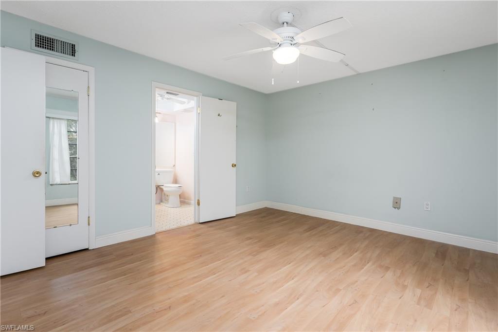 28 Watercolor Way, Unit 28 Naples, FL 34113 - Photo 10 of 29 an empty room with wooden floor and ceiling fan